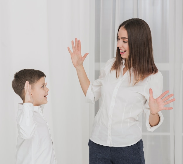 Adorable son playing with his mother