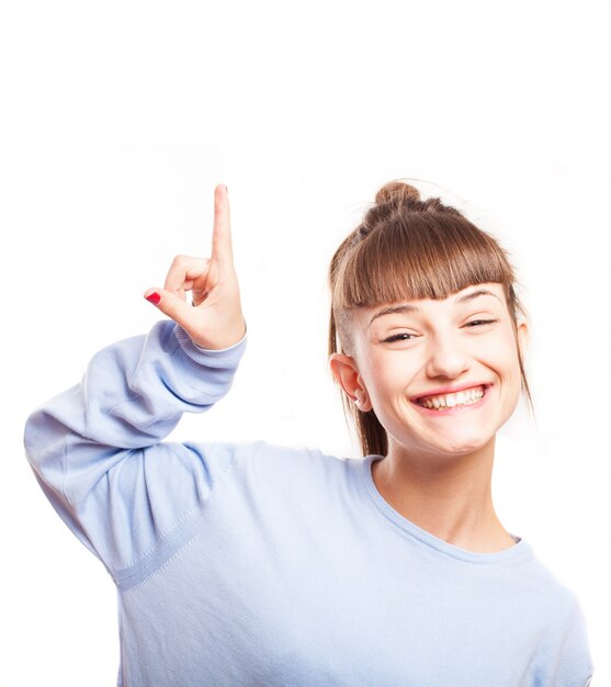 Adorable teen pointing up with her right hand