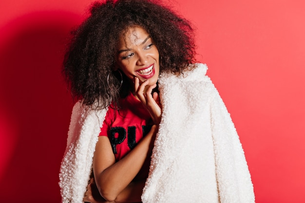 Free photo adorable woman in coat posing with happy smile