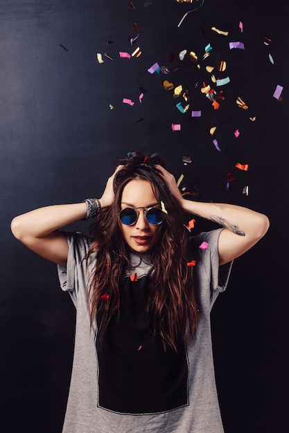 Adorable woman having fun with confetti