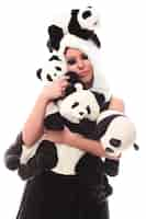 Free photo adorable woman with lots of stuffed pandas