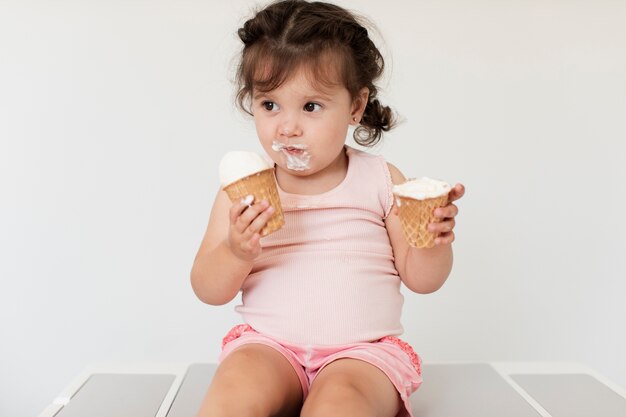 Adorable young baby girl with ice cream