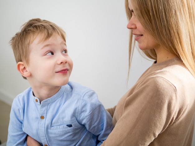 Free photo adorable young boy looking at his mother