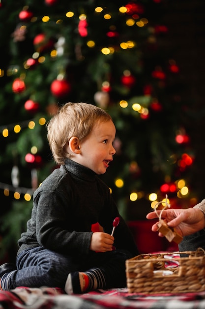 Adorable young boy playing with christmas toys