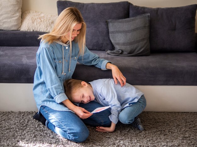 Adorable young boy playing with his mom