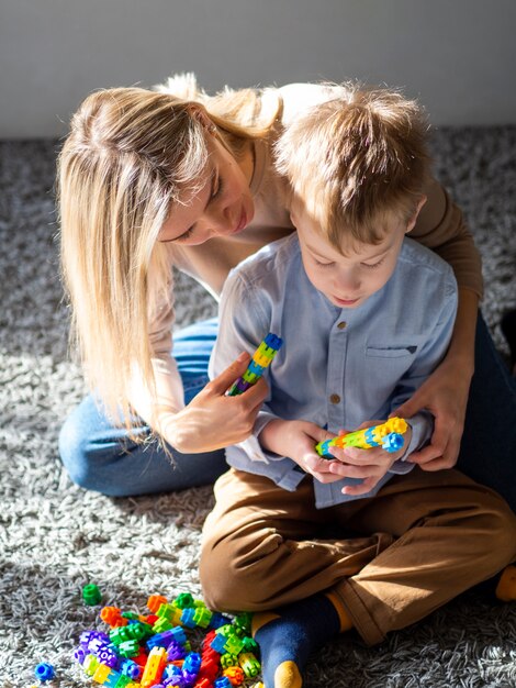 Adorable young boy playing with toys