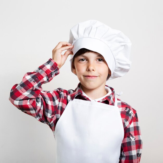 Adorable young boy ready to cook