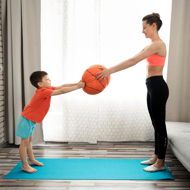 Adorable young boy training with his mother