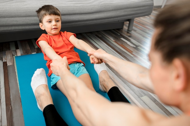 Adorable young boy training with mother