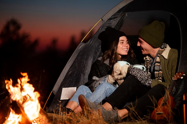 Free photo adorable young couple next to a bonfire