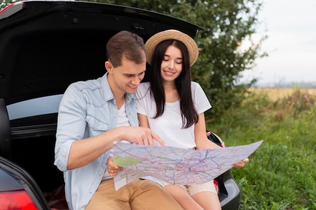 Adorable young couple checking local map