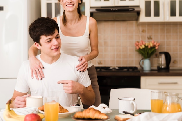 Adorable young couple together in the kitchen