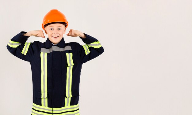 Adorable young fireman posing