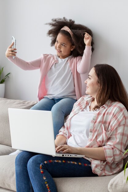 Adorable young girl having good time with mother