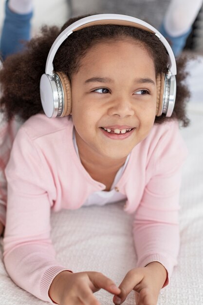 adorable young girl listening to music