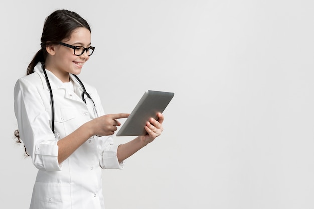 Adorable young girl using a tablet with copy space