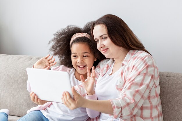 Adorable young girl watching cartoons with mother