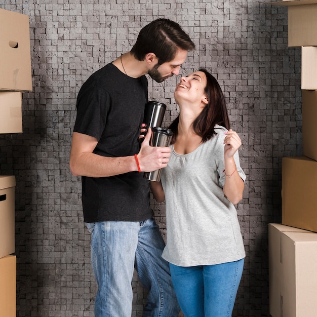 Adorable young man and woman celebrating relocation