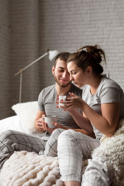 Adorable young man and woman having coffee