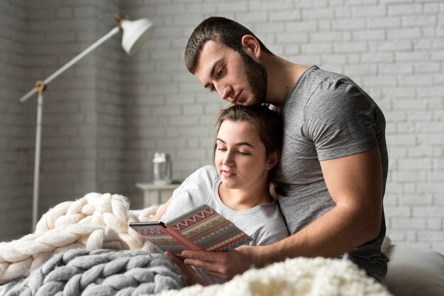 Adorable young man and woman together in bed