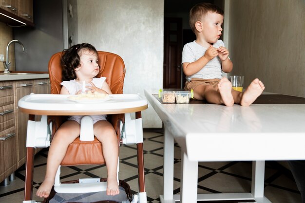 Adorable young siblings looking away