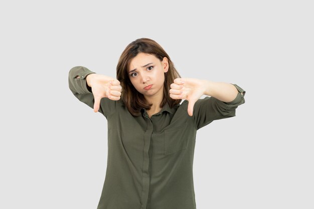 Adorable young woman in casual outfit standing and posing