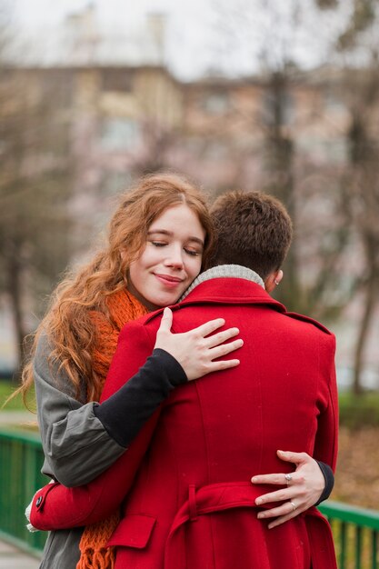 Adorable young women hugging each other