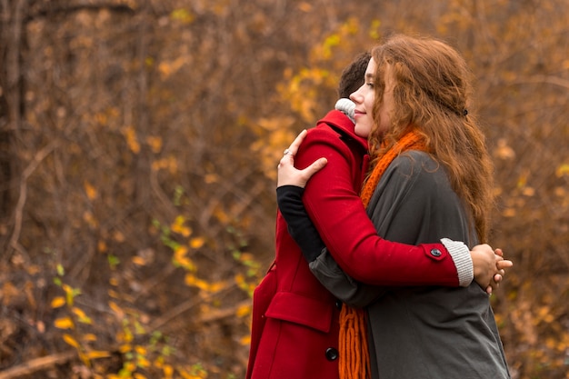 Free photo adorable young women hugging each other