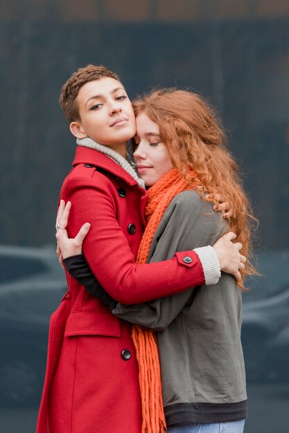 Adorable young women hugging