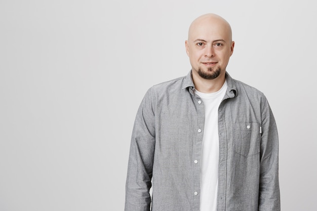 Adult bald man with beard smiling