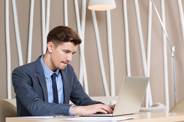 Adult Businessman Working Hard on Laptop in Office