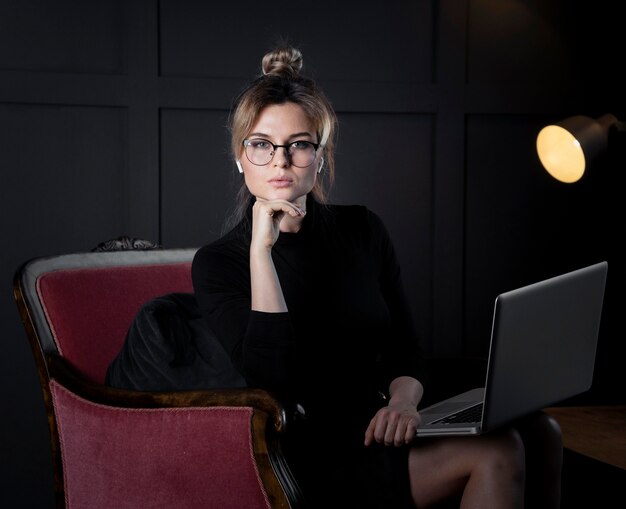 Adult businesswoman with eyeglasses posing