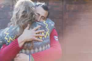 Free photo adult couple embracing at wall