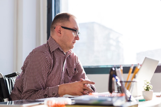 Adult disabled man working at the office