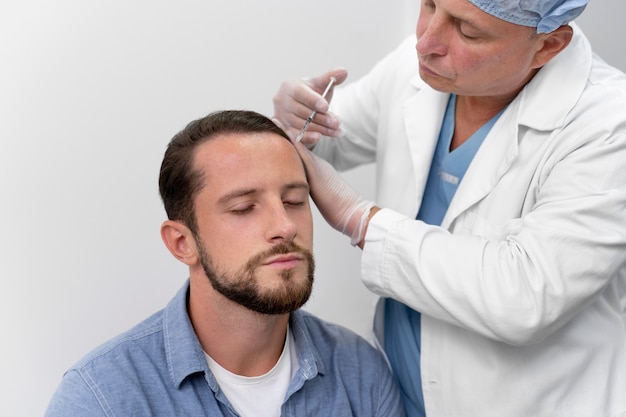 Adult male doing a follicular unit extraction