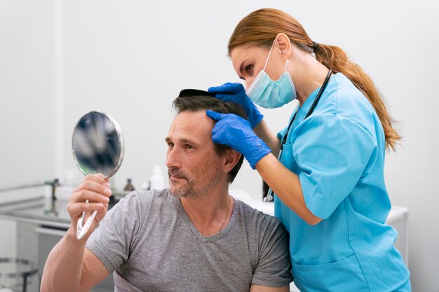 Adult male getting a hair loss treatment