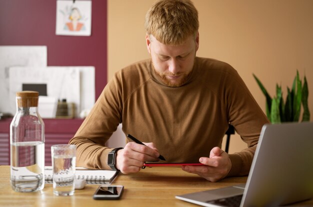 Adult male illustrator working on tablet device