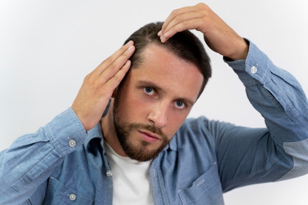 Adult male looking at his hair