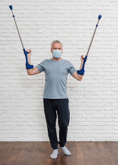 Adult male posing with his crutches