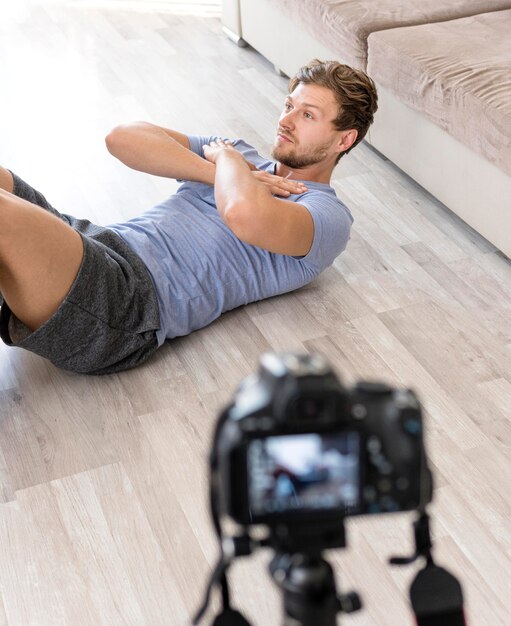 Adult male recording himself training at home