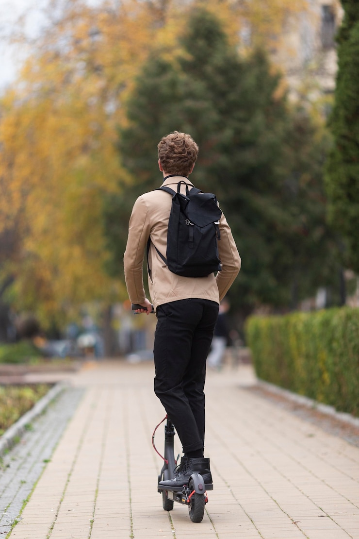 Free Photo adult male riding an electric scooter