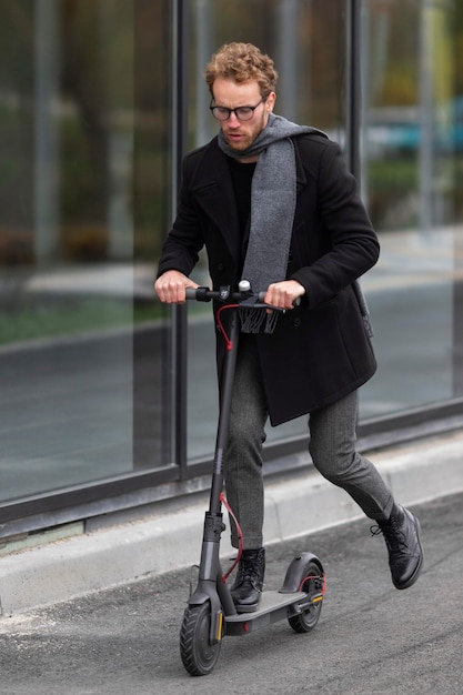 Adult male riding his electric scooter