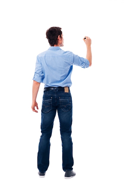 Adult male writing on the blank white wall