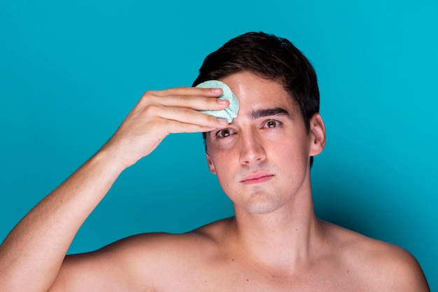 Adult man applying soap moisturizer