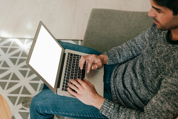 Free photo adult man browsing laptop in living room