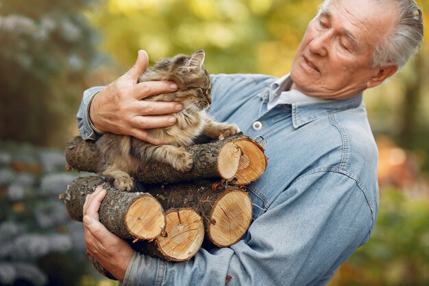 Adult man holding firewood and a cat