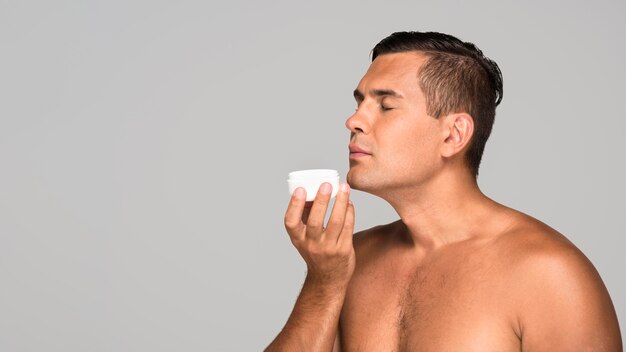 Adult man smelling cream