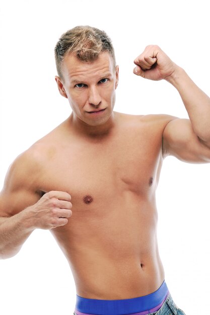 Adult man without shirt posing in studio