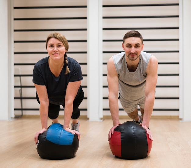 Adult man and woman exercising together