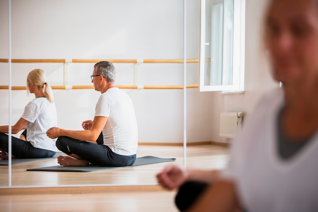 Adult man and woman meditating yoga